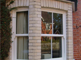 Angled brick bay window with hung sash windows