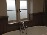 Bathroom with triple pencil ogee profile uPVC double glazed window with classic hardware